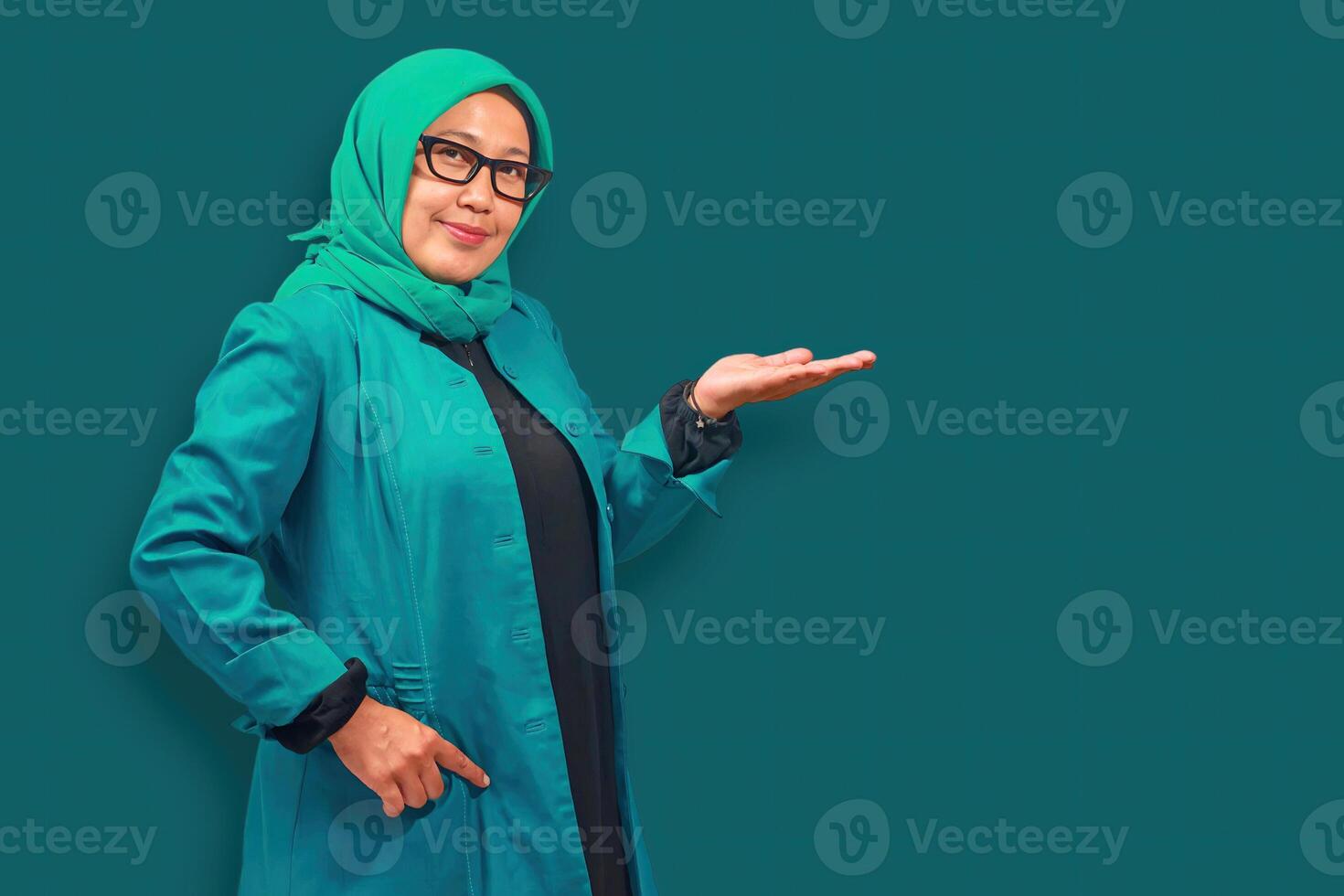 Confident Muslim Woman Presenting in Green photo