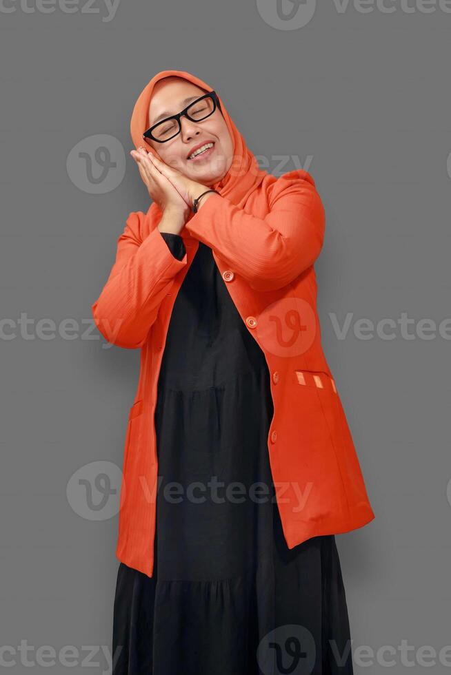 Cheerful Muslim woman in orange hijab smiling warmly with a relaxed and happy expression photo