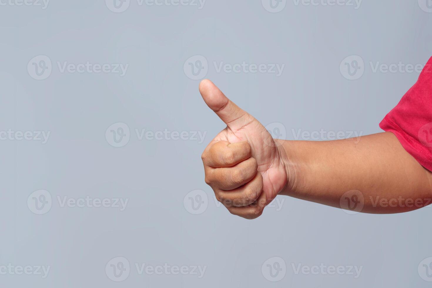 Thumbs up hand gesture expressing approval, success, and positivity photo