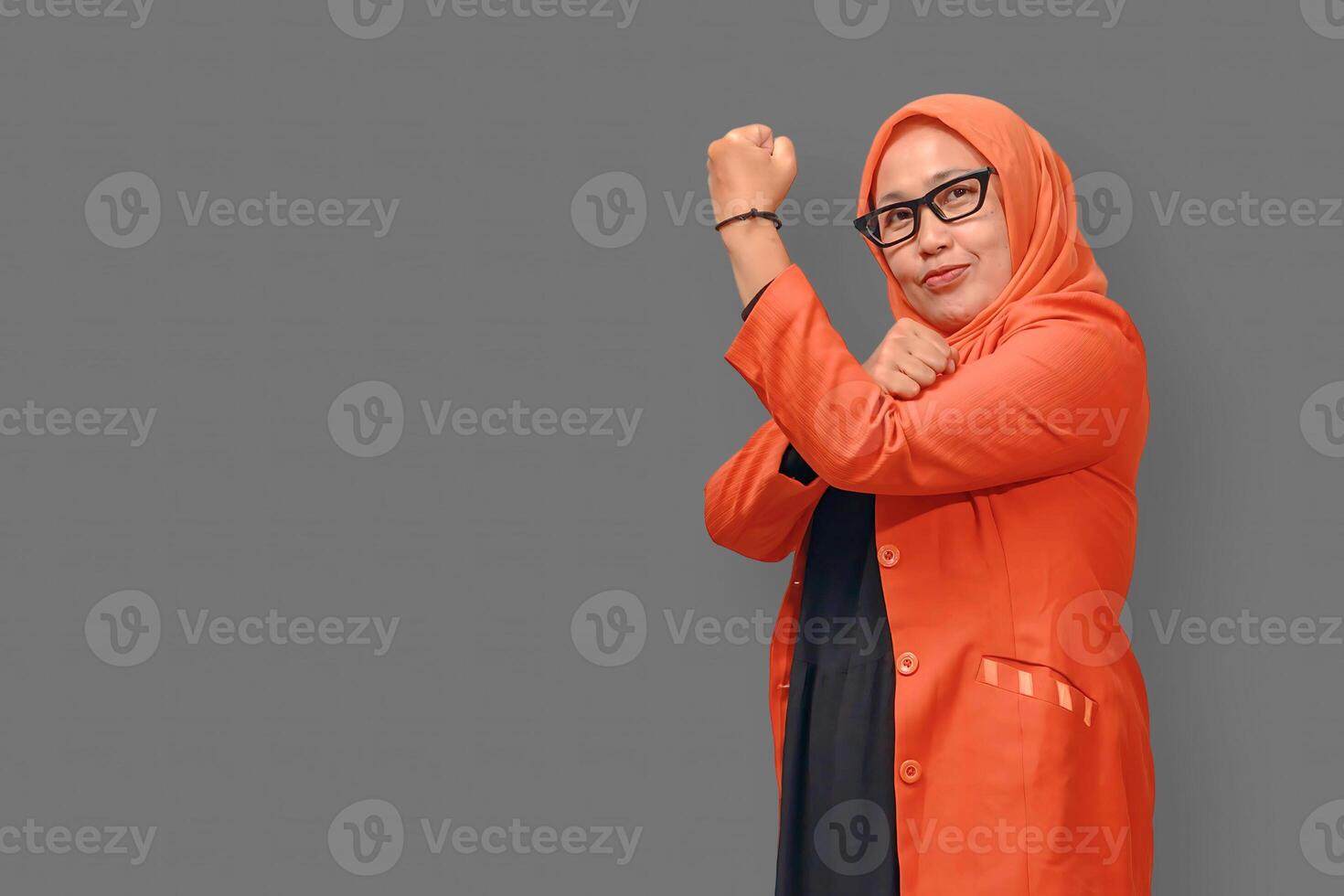 Confident Muslim woman in hijab showing strength pose with a smile photo