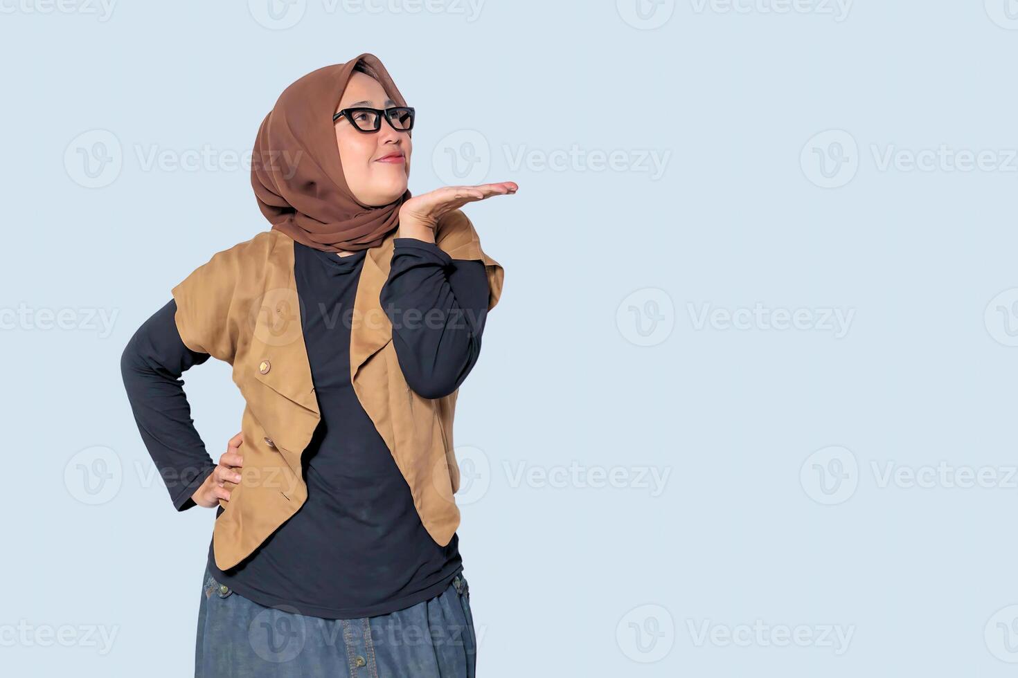 A confident Muslim woman in a hijab striking a playful and stylish pose photo