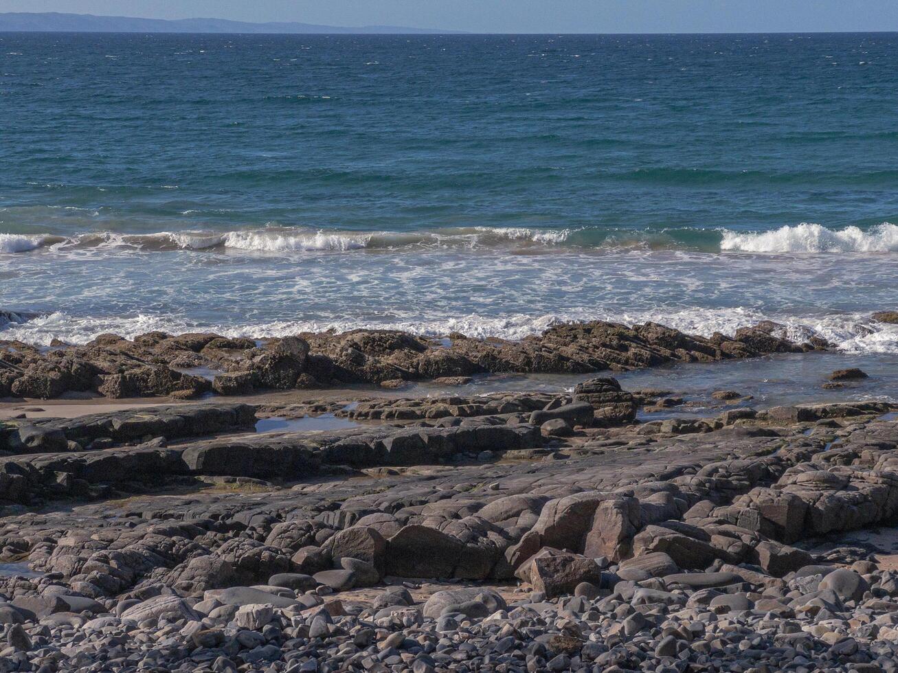 waves crashing on the beach photo