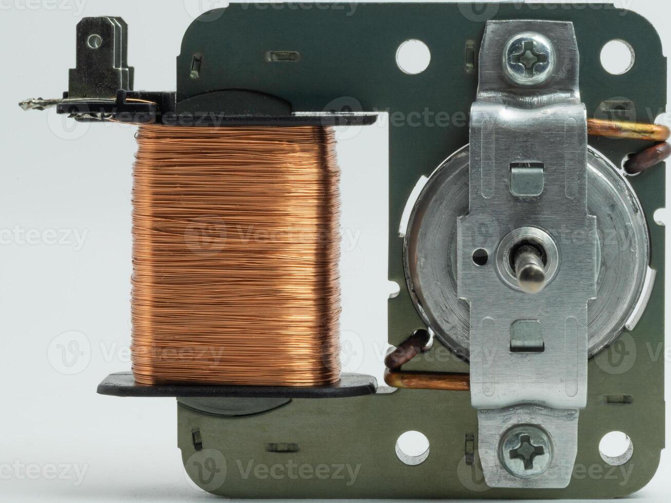 Closeup view of electric fan motor highlighting the copper winding and assembly components photo