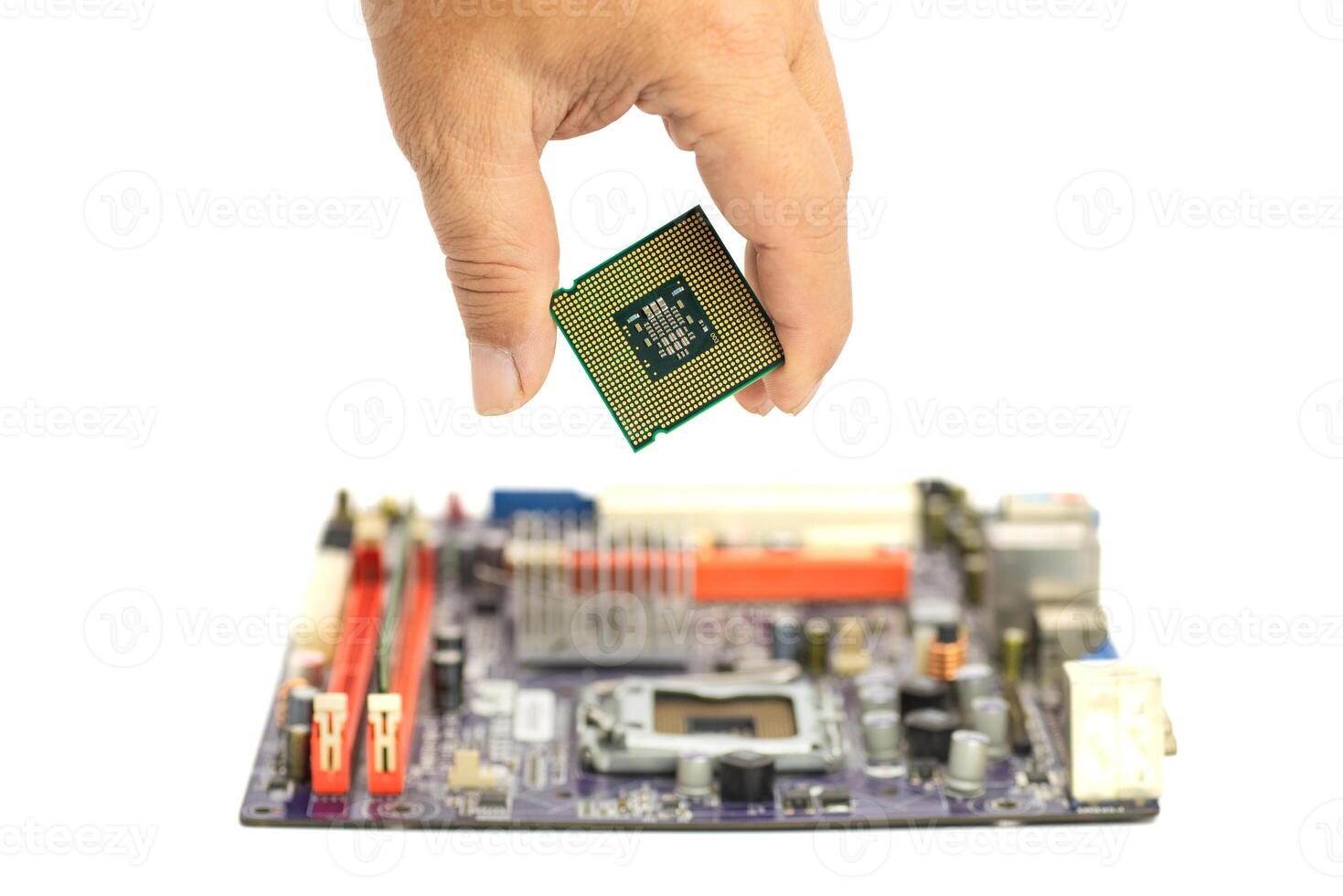 Hand executing delicate installation of CPU onto mainboard photo