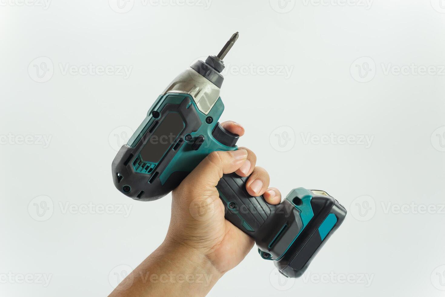 Cordless electric drill held firmly in hand, showcasing power tool features and design photo