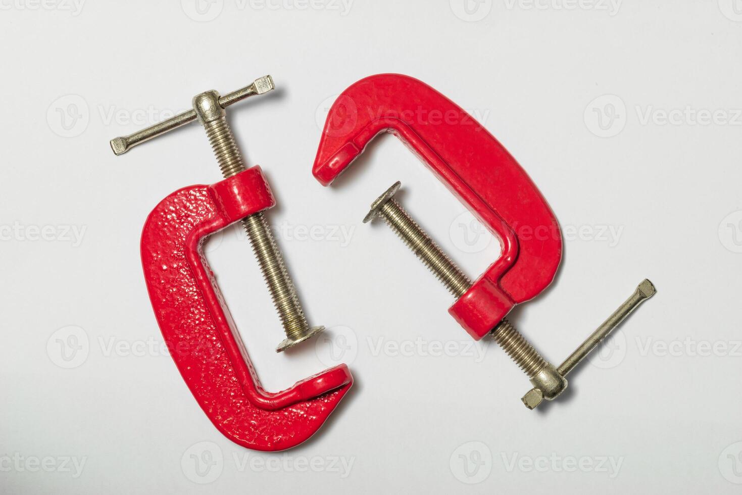 Mini C clamps isolated on a white background ready for woodworking tasks photo