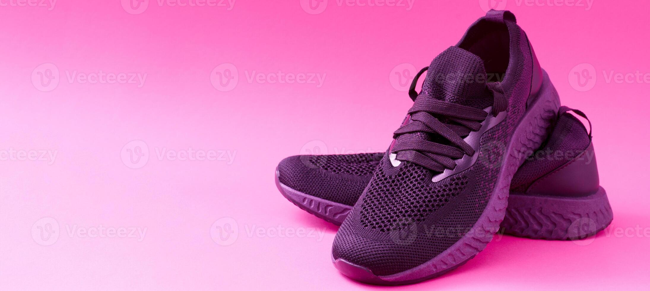 Sneakers concept with place for text. Close-up of pink sneakers on a bright background. Sports shoes for running and fitness. A comfortable everyday pair of shoes. photo