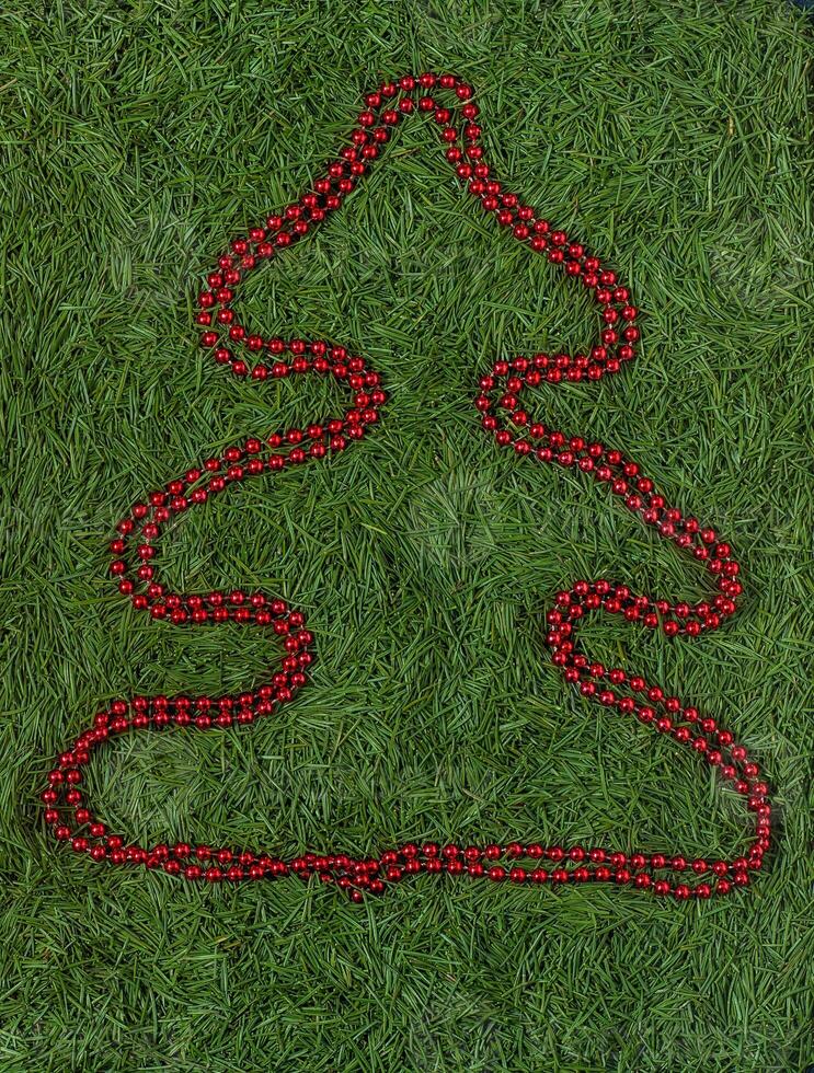 Red Beaded Christmas Tree on Green Needles photo