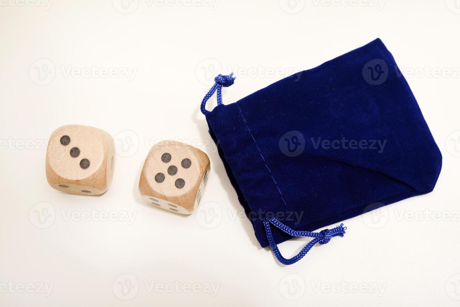 Dice cubes resting on a white canvas. Assorted dimensions. photo