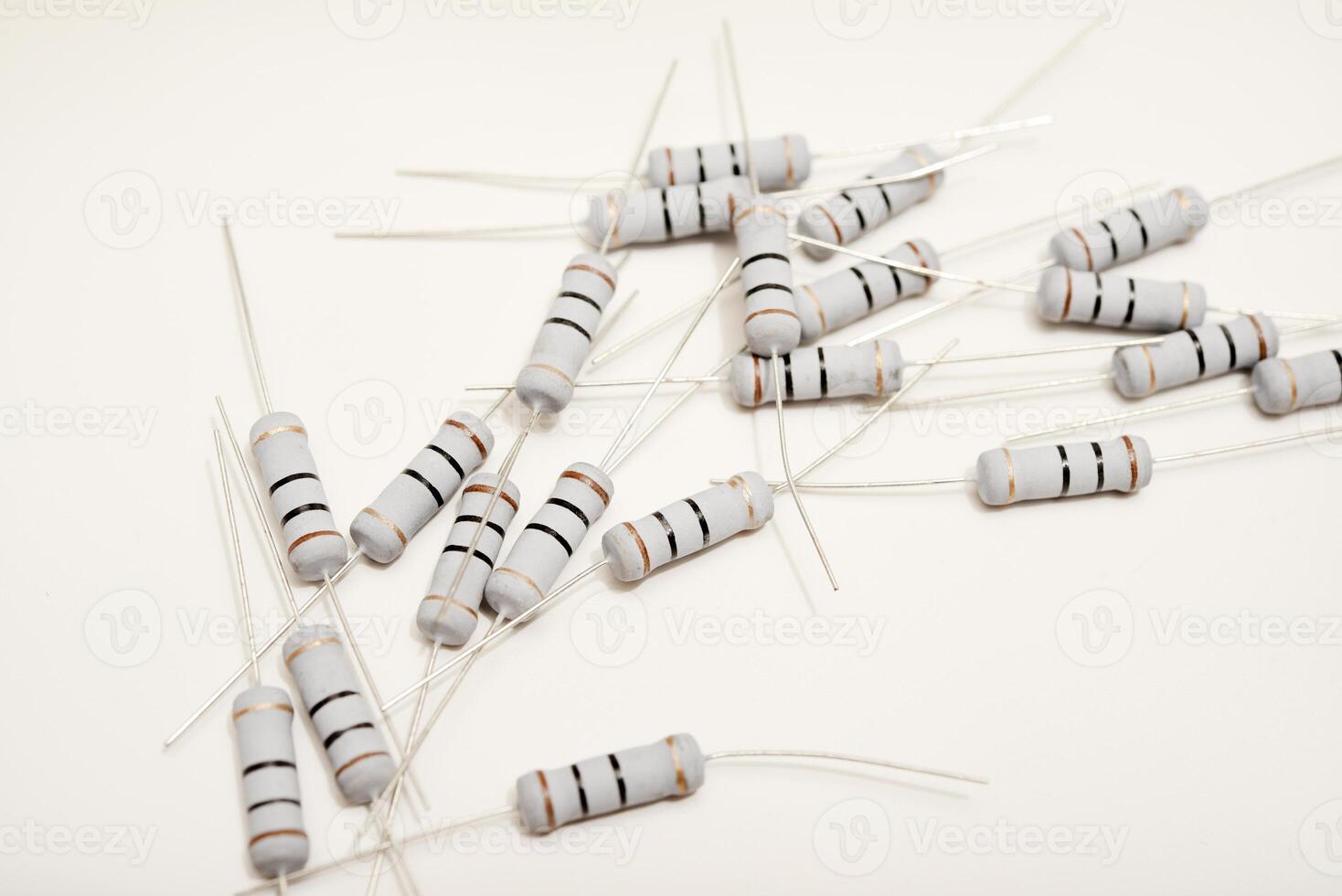 Ceramic-based resistors positioned on a pristine white backdrop. Circuit elements for electronic gadgets. photo