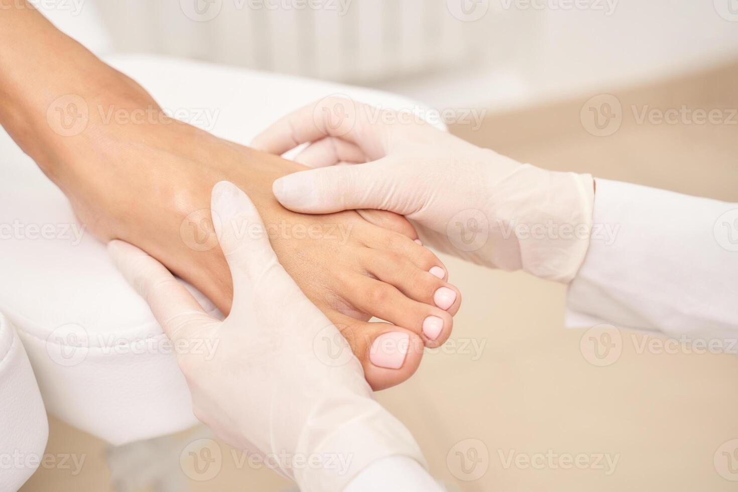 Professional foot massage by gloved hands in spa setting for relaxation and wellness. photo