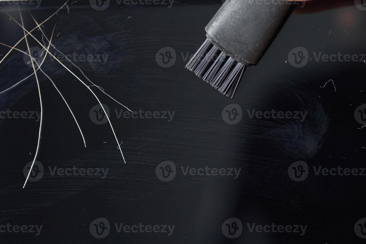 Cleaning computer screen with brush and removing dust and hair for maintenance. photo