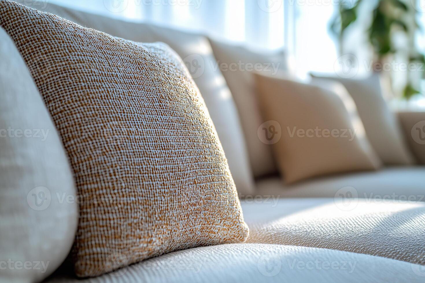 Cozy home interior with textured cushions on a stylish couch in warm afternoon light. Soft, inviting cushions lay on a modern couch, illuminated by warm afternoon sunlight photo