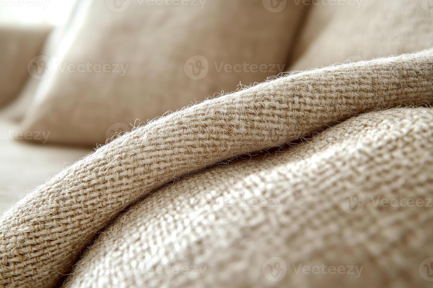 Close-up of cozy home textures showcasing a soft woven fabric couch in a modern living space during daylight. A detailed view of a soft woven fabric couch reveals the inviting textures of home decor photo