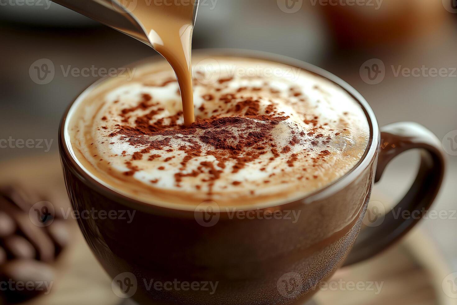 Hot coffee being poured into a cup with creamy froth and chocolate dust on a wooden table with coffee beans. Barista pours coffee into a dark cup, creating a swirl of frothed milk and chocolate dust photo