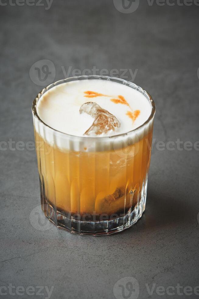 A cocktail with orange juice and ice photo