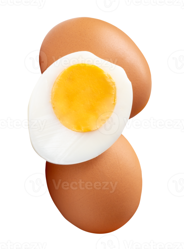 Front view of raw brown chicken eggs and cooked or boiled chicken egg with egg yolk in half in small pile isolated with clipping path in file format png