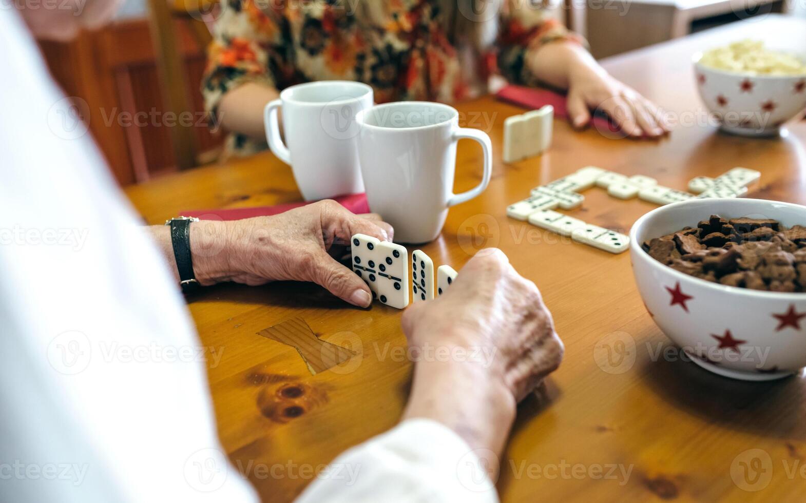 A woman playing dominoes with her husband and two children photo