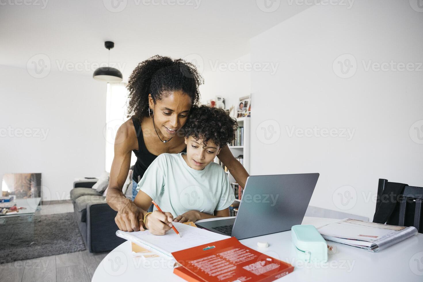 A other and a child working on a laptop photo
