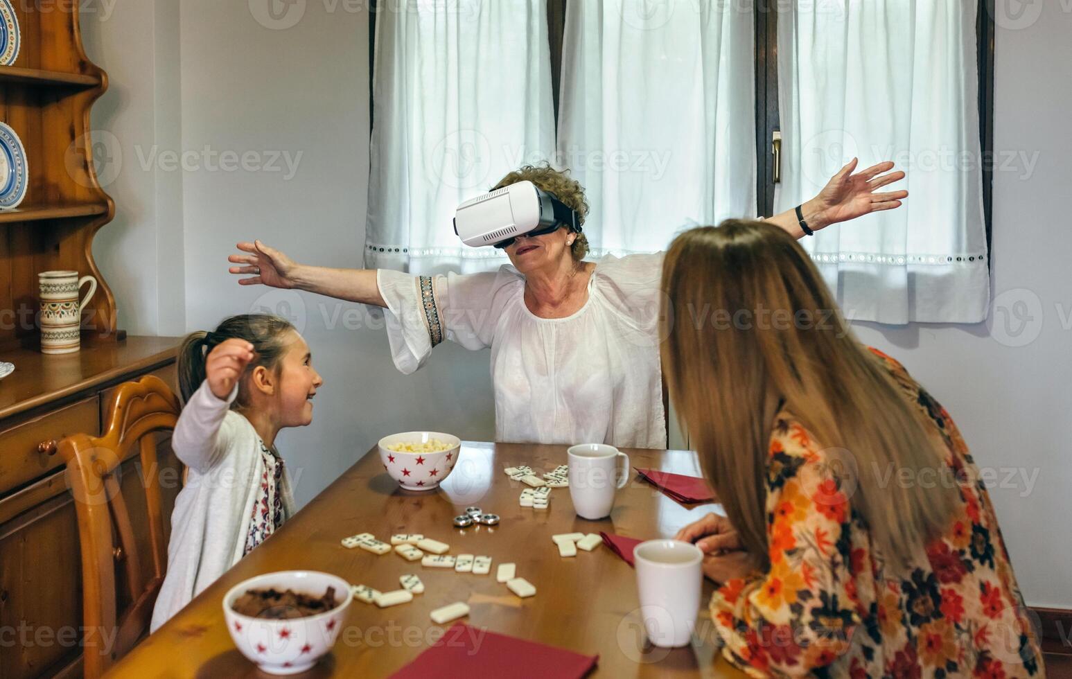 A woman and two children playing with virtual reality glasses photo