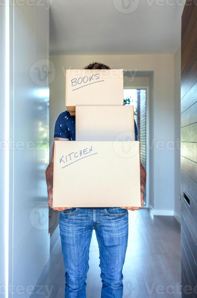 A man holding three boxes with the words move and sell on them photo