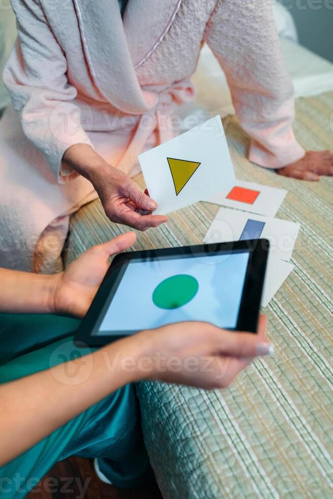 A woman in a robe is playing with a tablet photo
