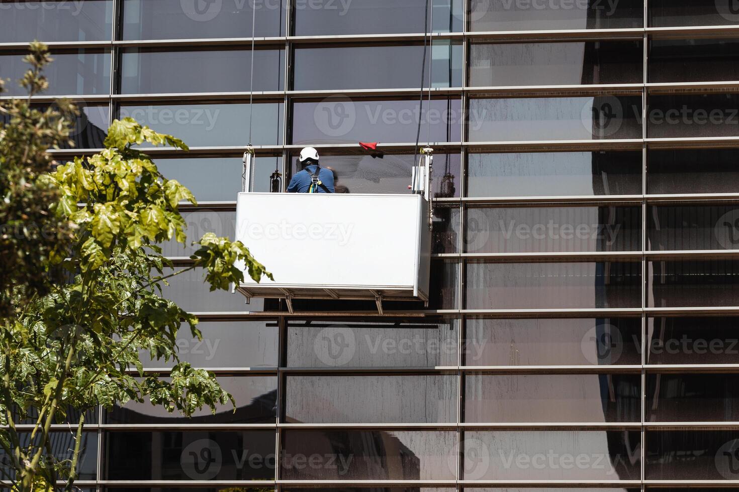 A man is working on a window cleaning machine photo