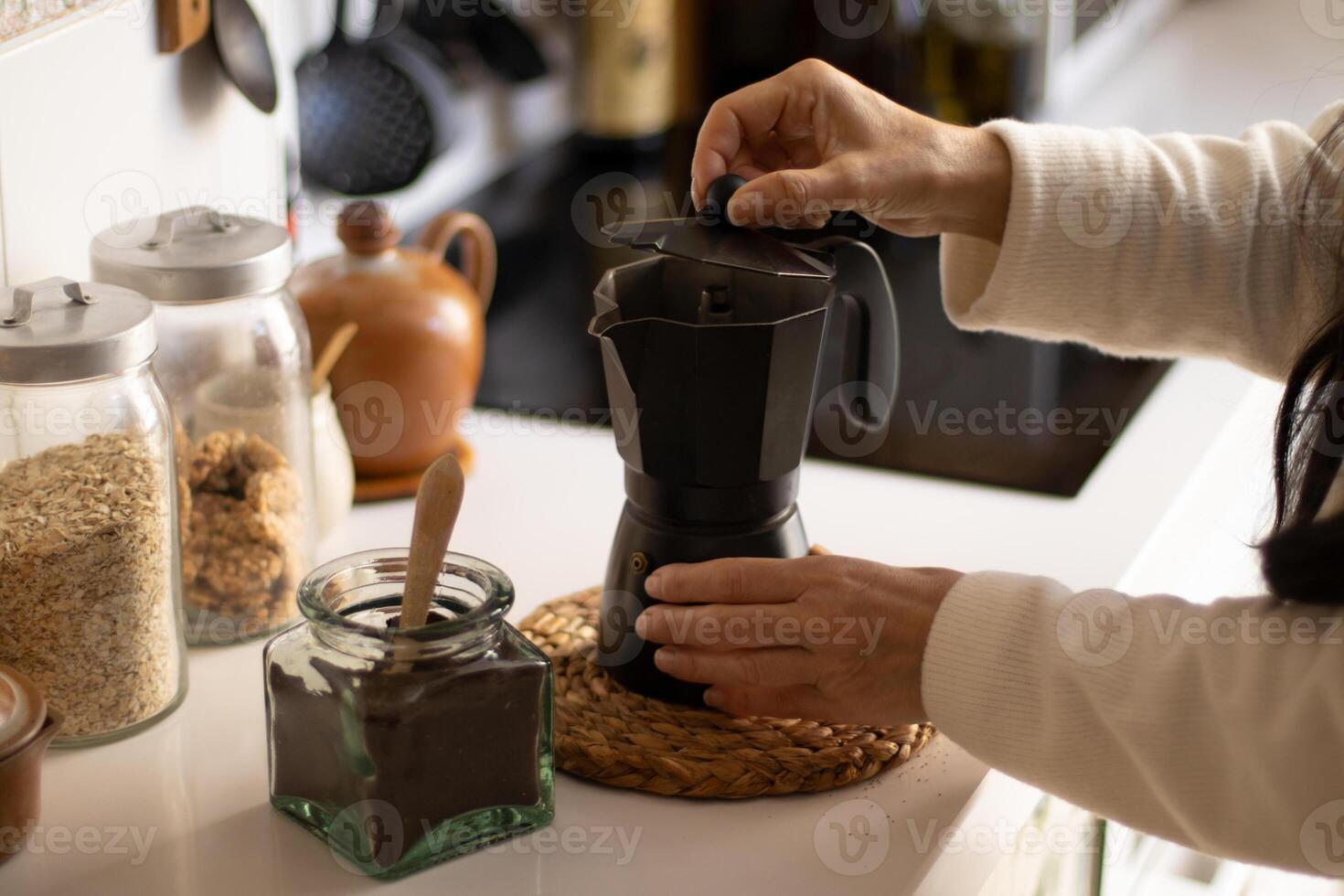 A person is pouring coffee into a coffee maker photo