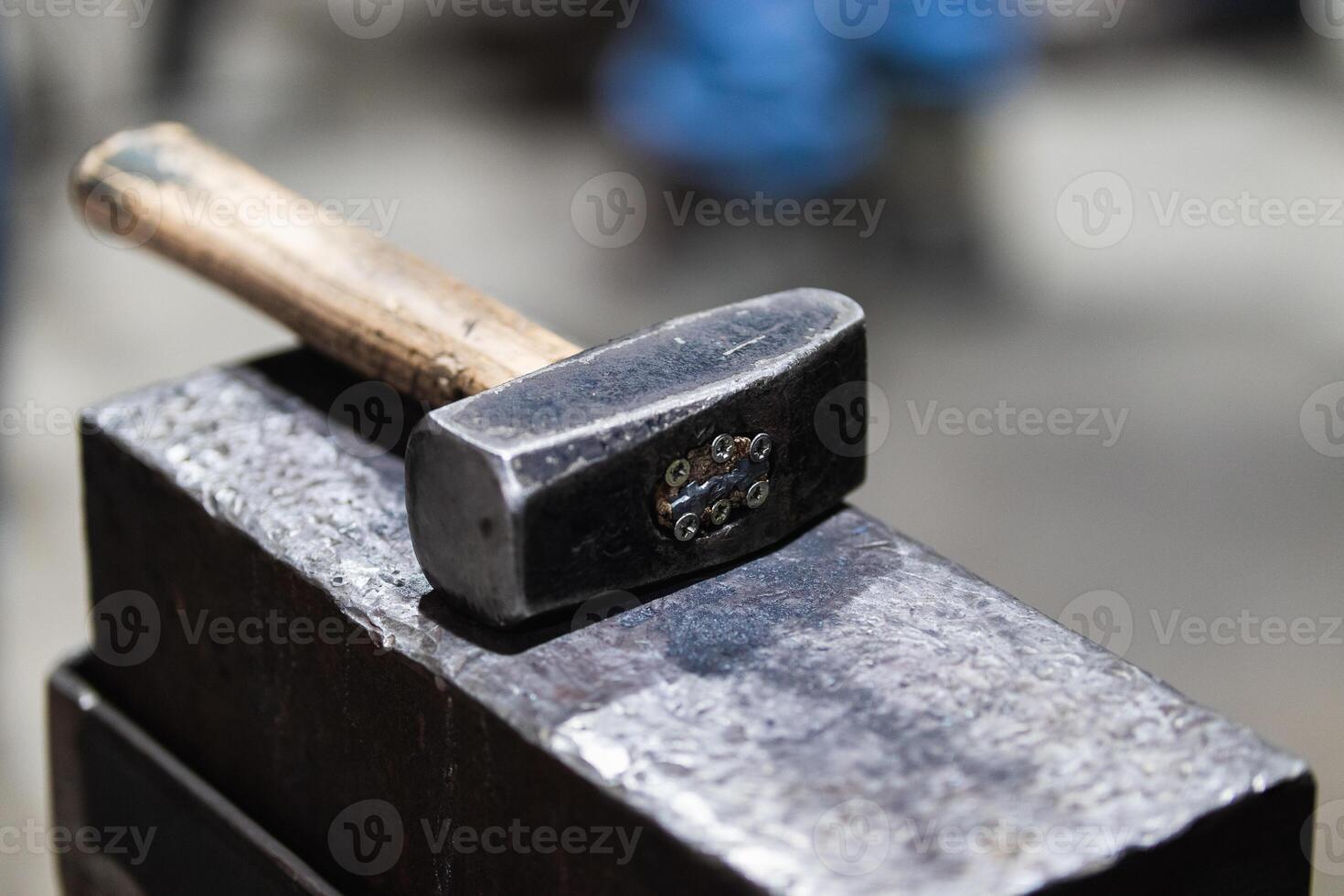A hammer sitting on top of a piece of metal photo