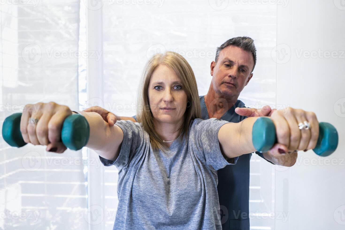 A man and woman doing dumbbell exercises photo
