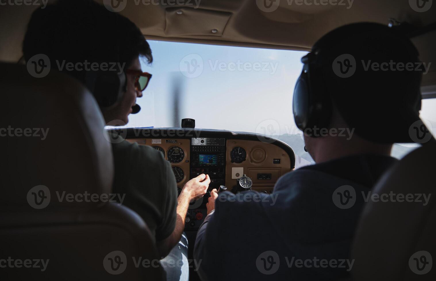 Two men in the cockpit of a small plane photo