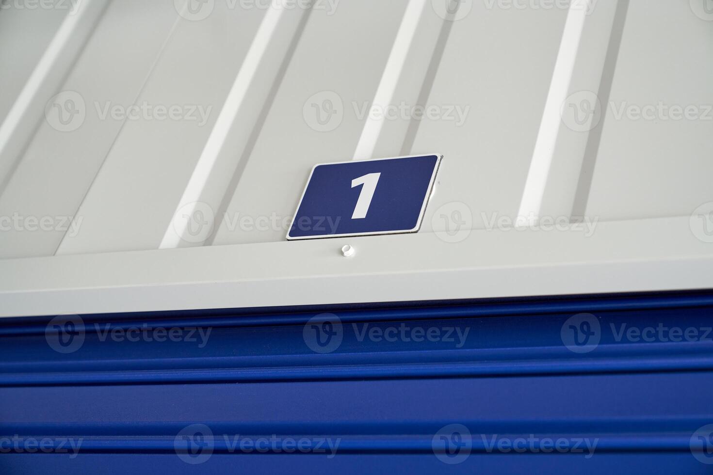 A blue and white storage unit with a number one on it photo