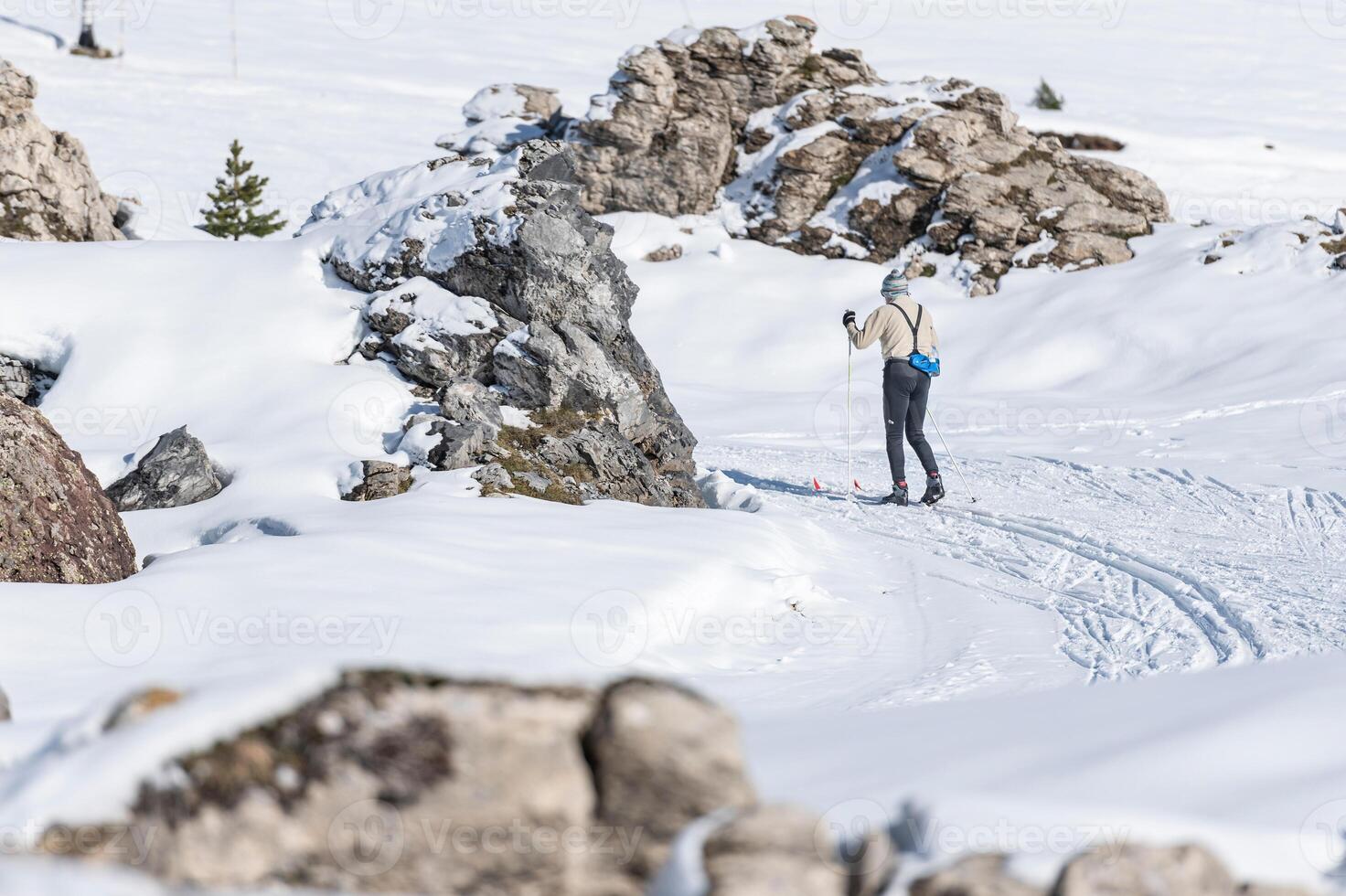 A person is skiing down a snowy mountain photo