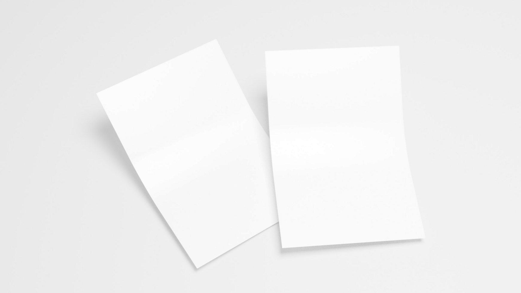 Two blank white sheets of paper on a white background psd