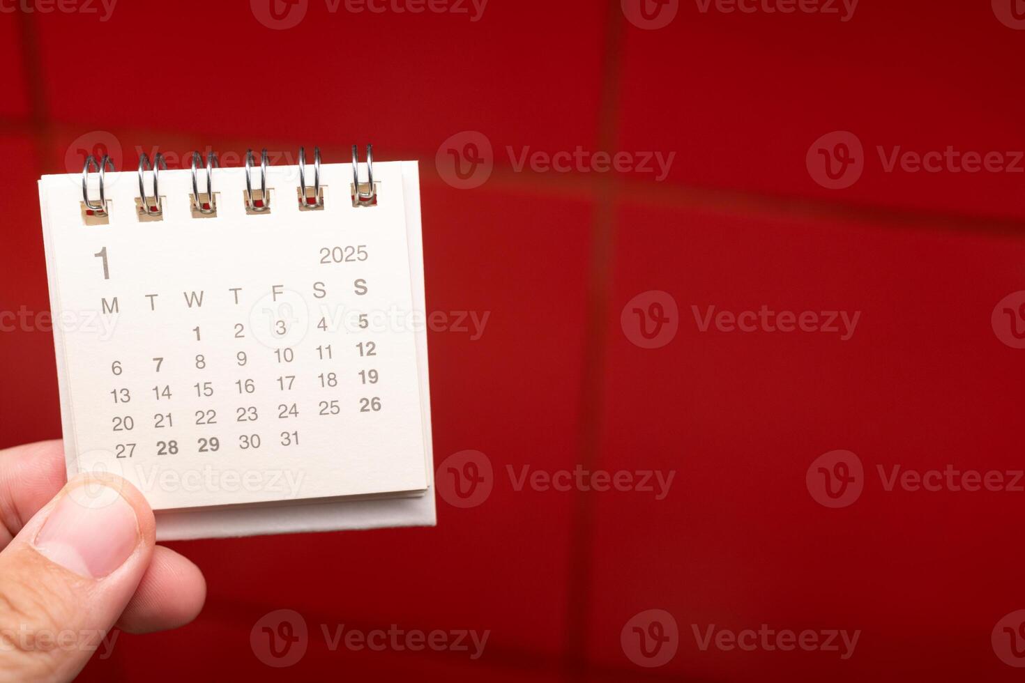Desk Calendar for JANUARY 2025 background. Calendar concept with 2025 JAN calendar on red background. photo