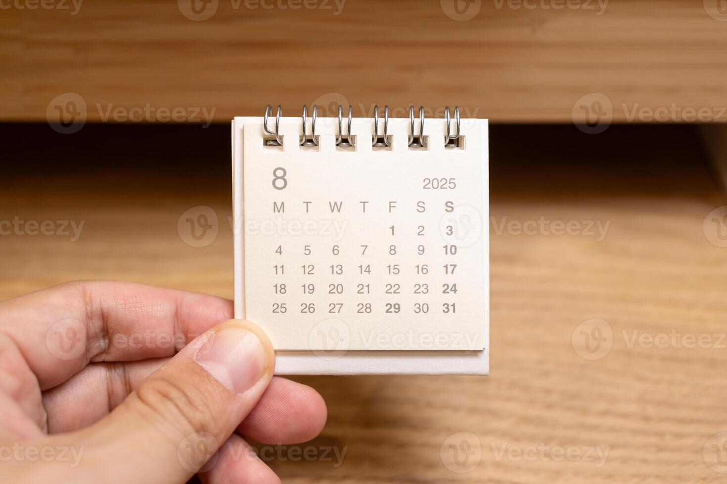 Desk Calendar for AUGUST 2025 background. Calendar concept with 2025 AUG calendar on wooden background. photo