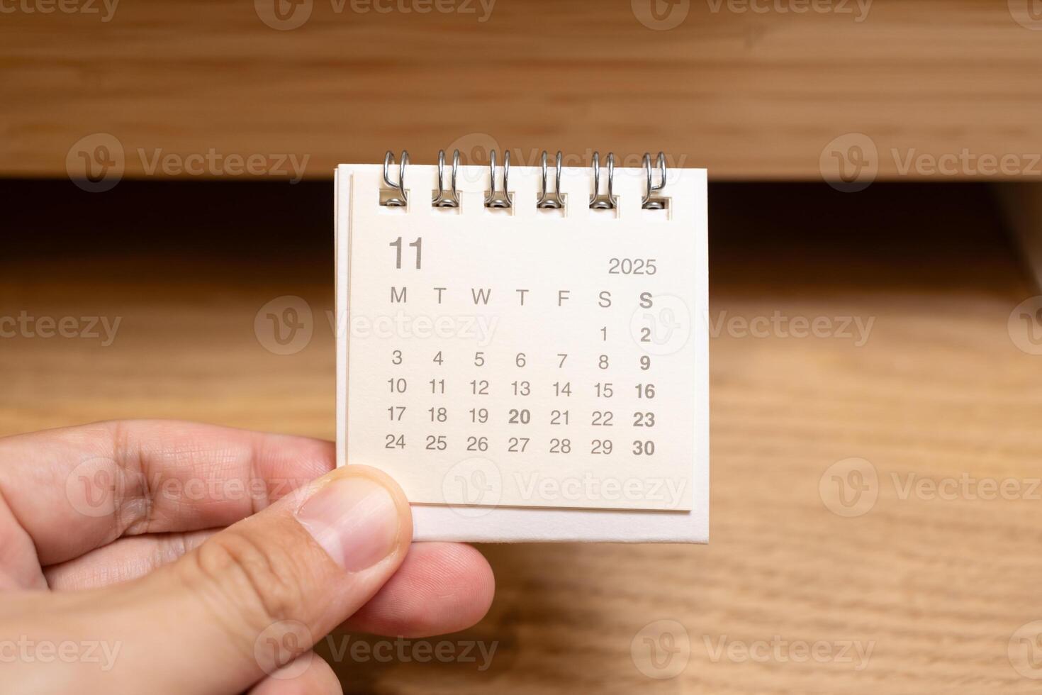 Desk Calendar for NOVEMBER 2025 background. Calendar concept with 2025 NOV calendar on wooden background. photo