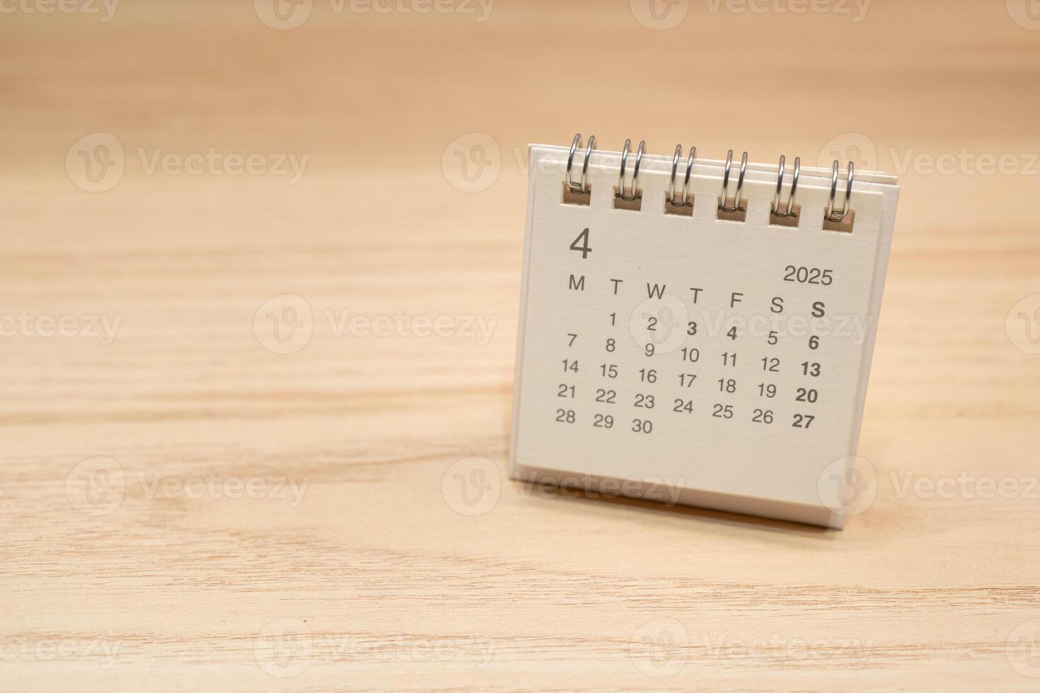 Desk Calendar for APRIL 2025 background. Calendar concept with 2025 APR calendar on wooden background. Copy Space for text. photo