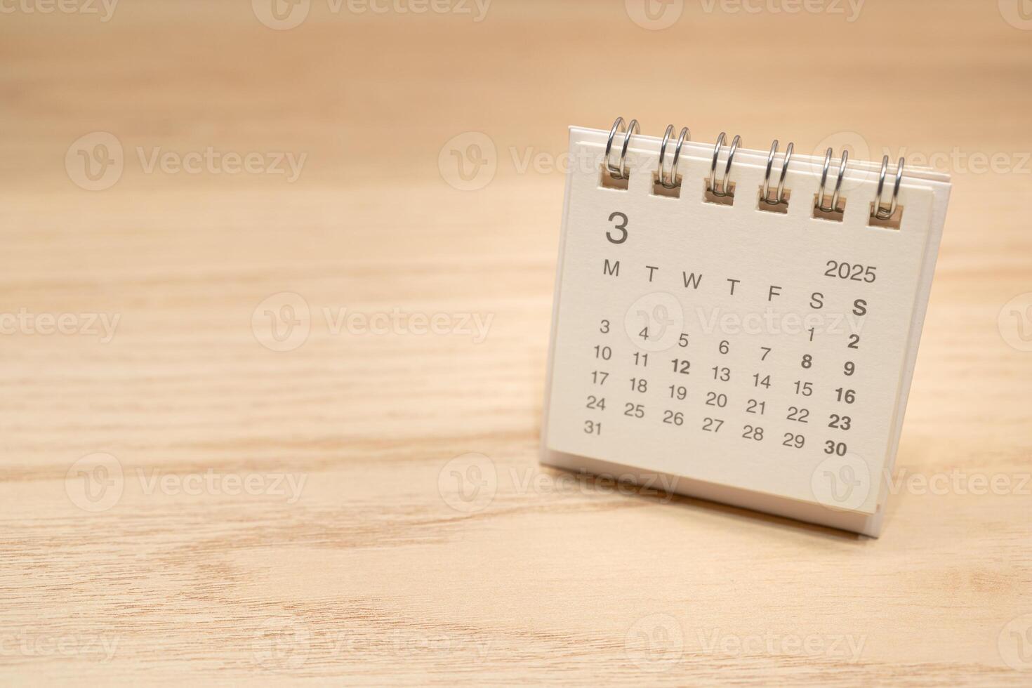 Desk Calendar for MARCH 2025 background. Calendar concept with 2025 MAR calendar on wooden background. Copy Space for text. photo