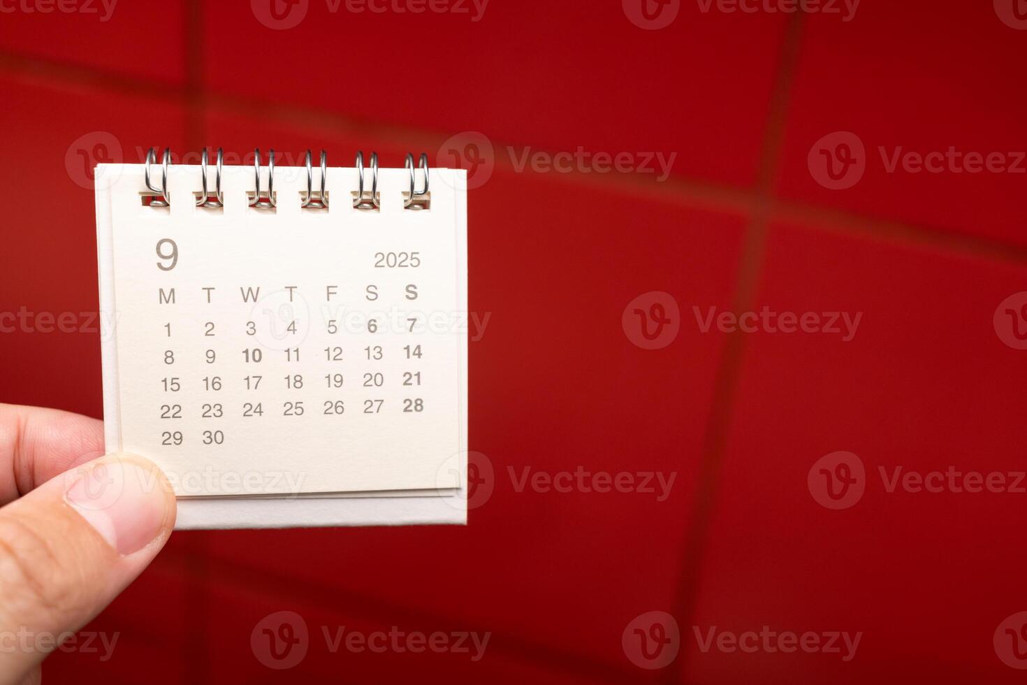 Desk Calendar for SEPTEMBER 2025 background. Calendar concept with 2025 SEP calendar on red background. photo