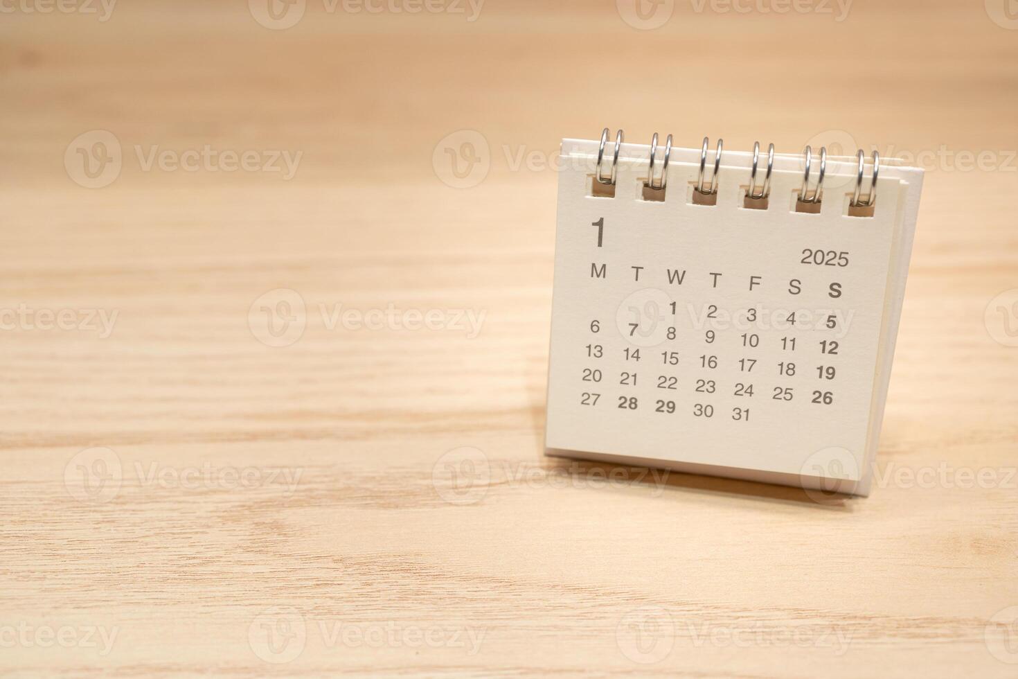 Desk Calendar for JANUARY 2025 background. Calendar concept with 2025 JAN calendar on wooden background. Copy Space for text. photo