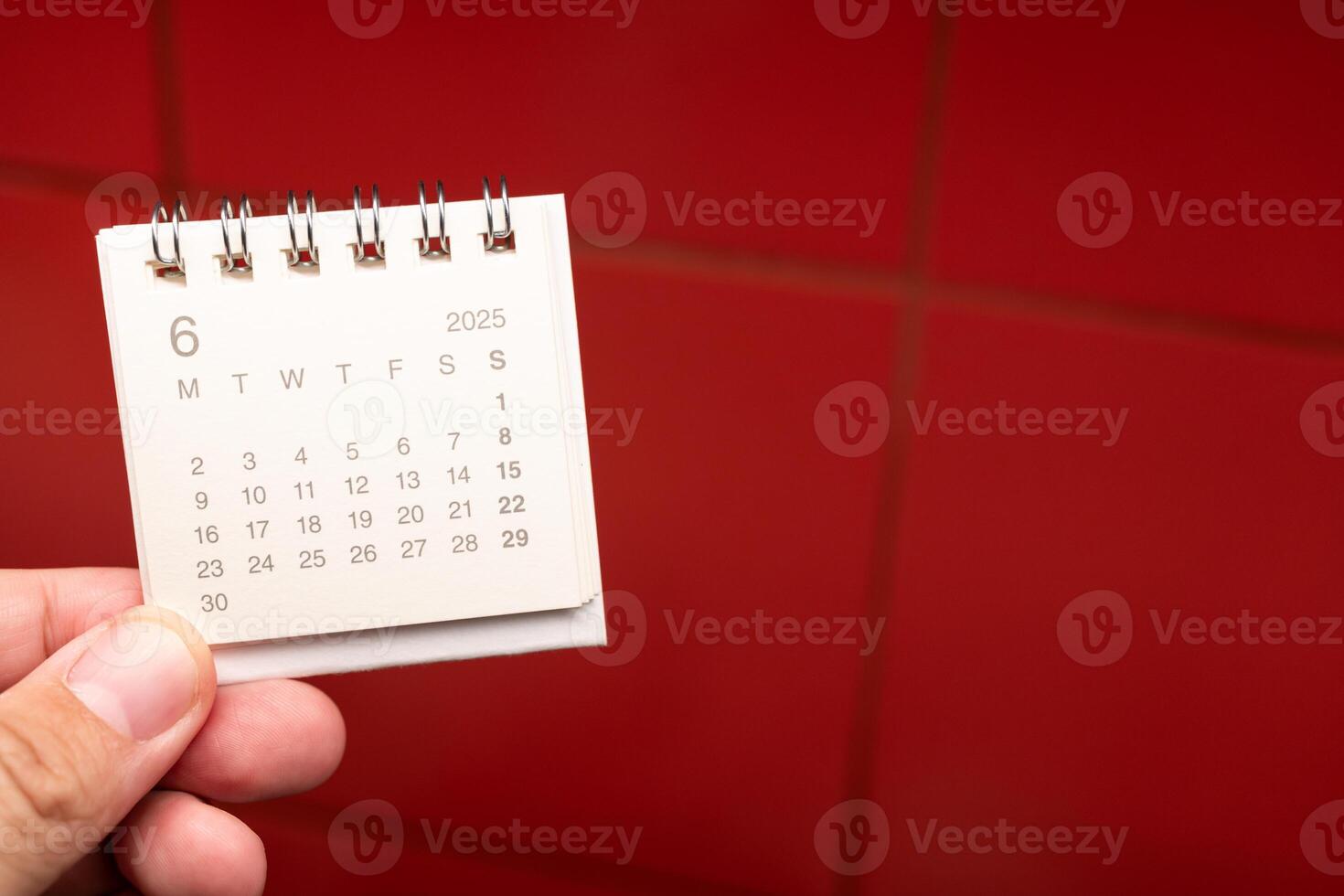 Desk Calendar for JUNE 2025 background. Calendar concept with 2025 JUN calendar on red background. photo