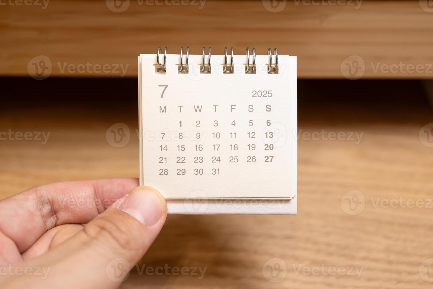 Desk Calendar for JULY 2025 background. Calendar concept with 2025 JUL calendar on wooden background. photo