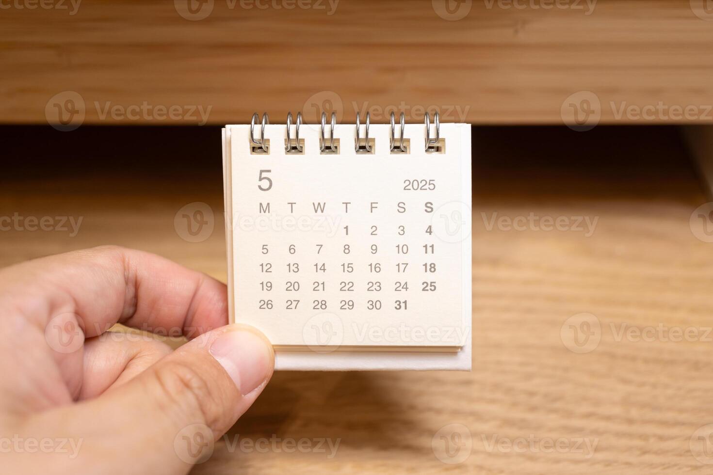 Desk Calendar for MAY 2025 background. Calendar concept with 2025 MAY calendar on wooden background. photo