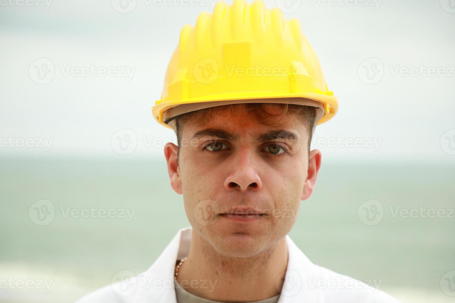 Angry Engineer About Bad Work Done By Workers Nervously Scolding Them On Beach photo