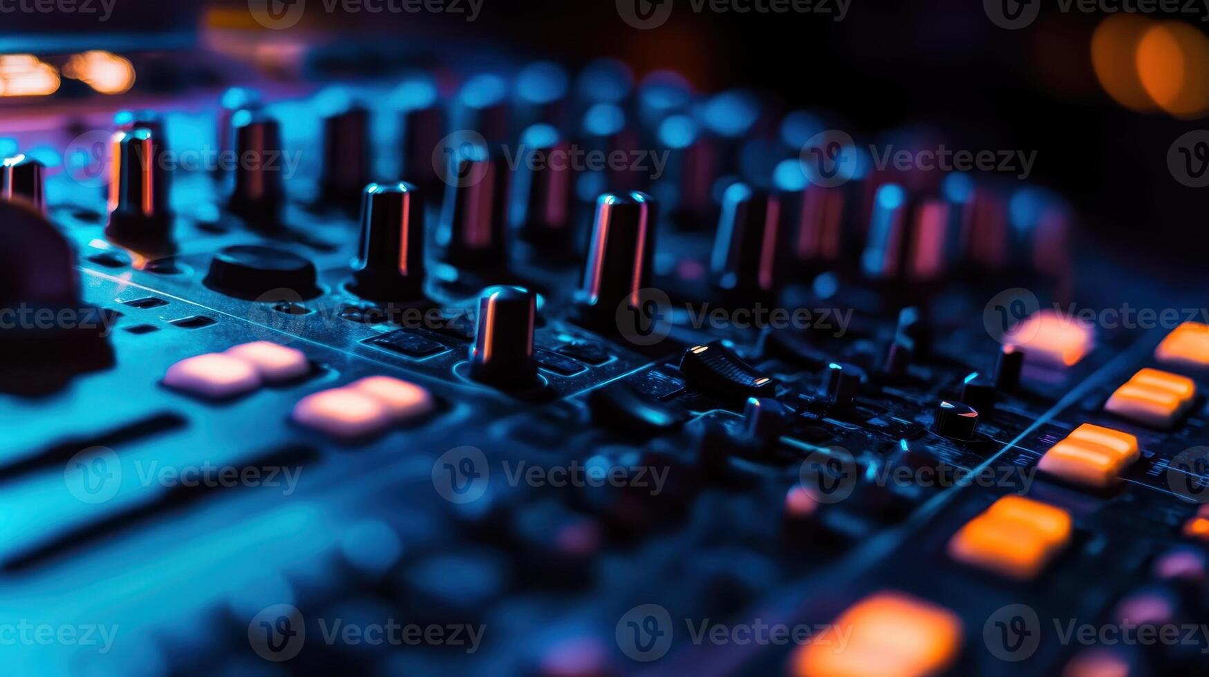 Close up of a professional music mixing console illuminated by colorful lights during a late-night recording session in a vibrant studio photo