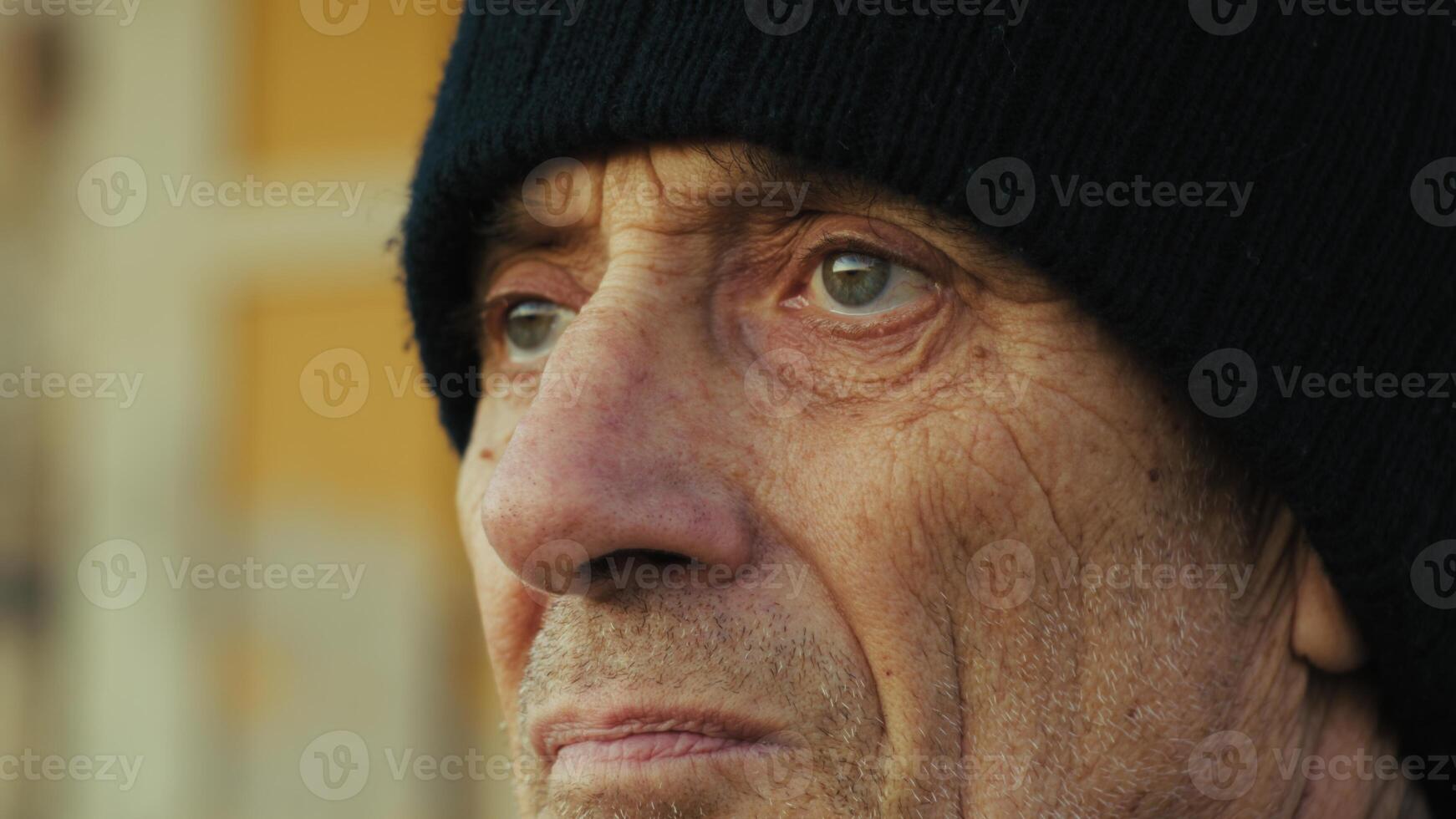 Old Worried Man Looks Around Close Up photo