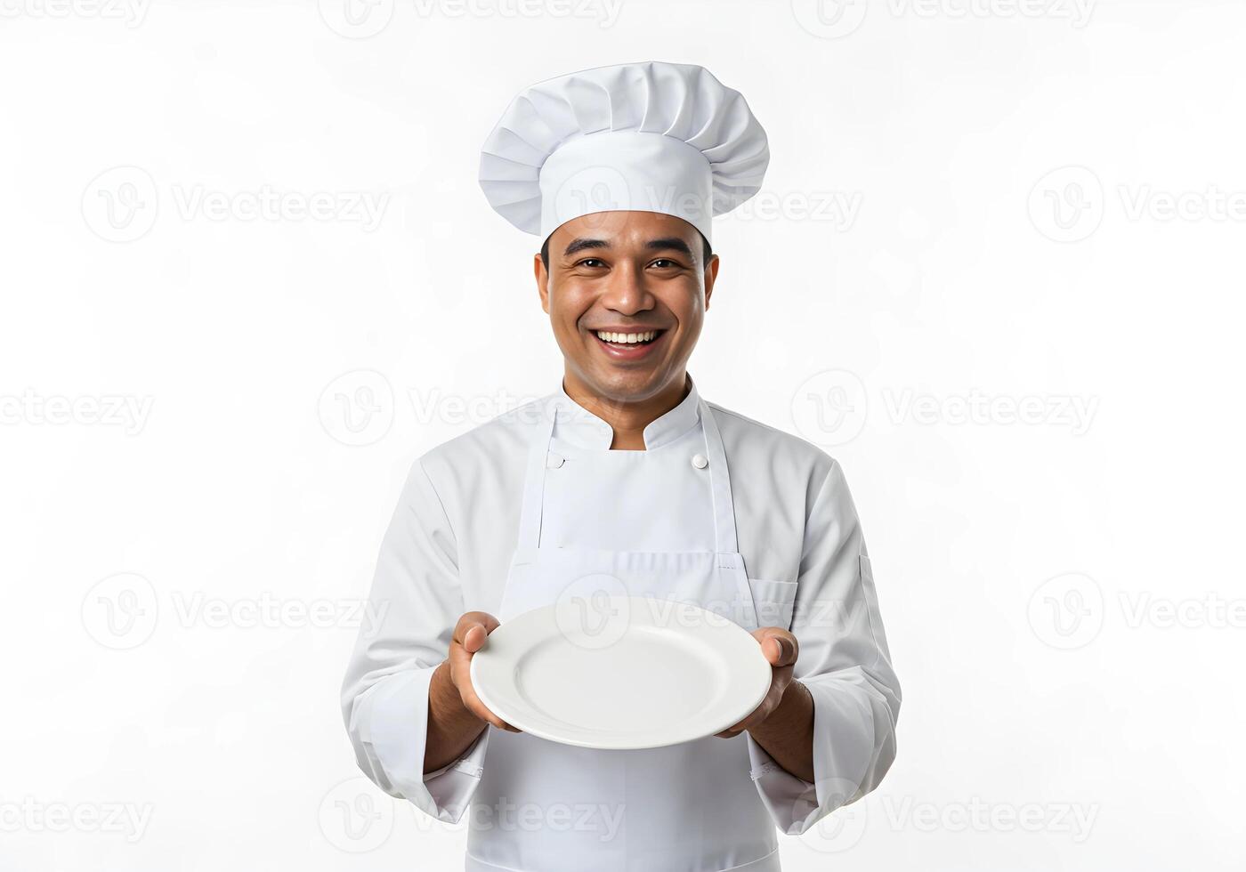 A smiling man in a chef's hat holding a plate photo