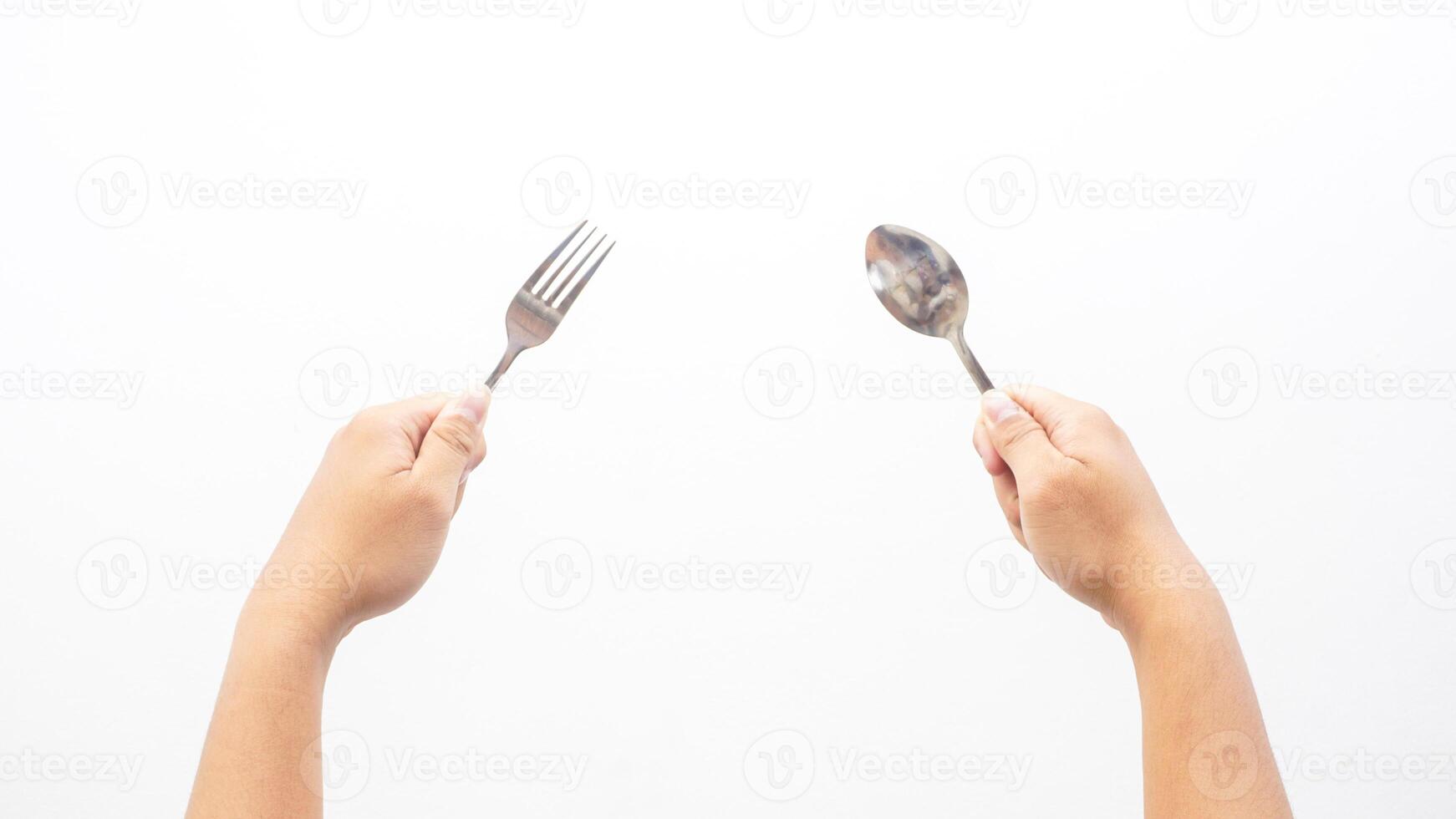 Hands of Man Holding Spoon and Fork Isolated on White Background photo