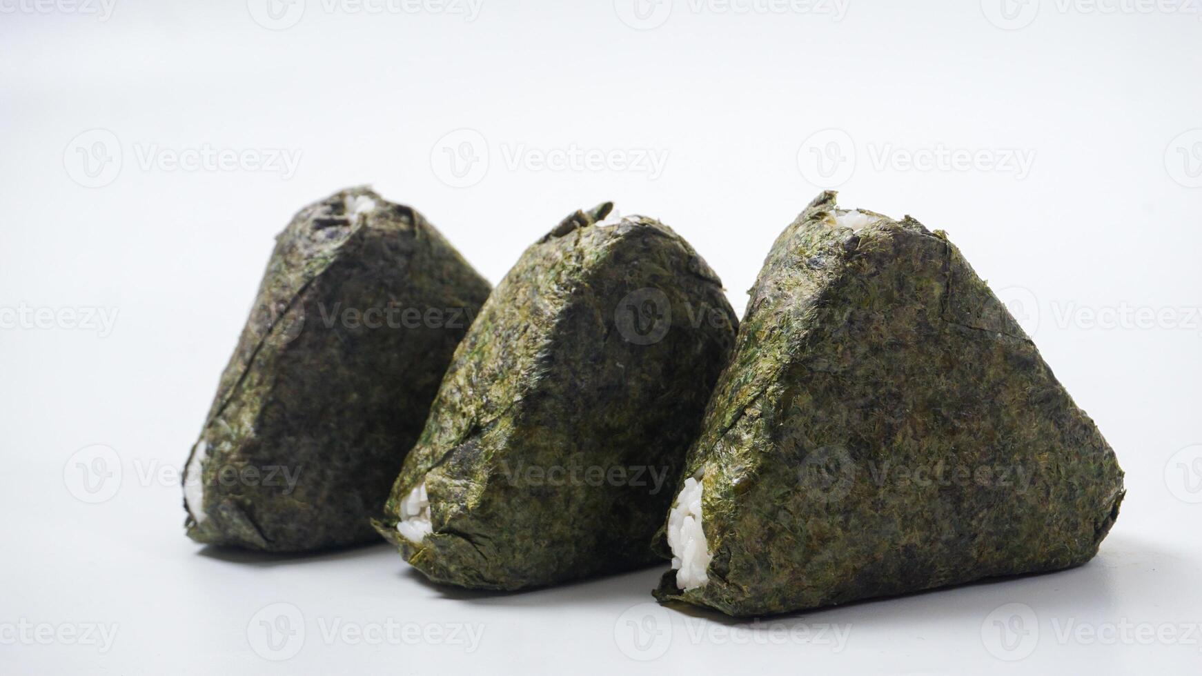 Three Japanese rice ball wrapped in nori dried seaweed or onigiri on isolated on white background photo